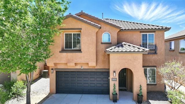 3604 Plano Vista Rd NE, Rio Rancho, NM 87124 - mediterranean / spanish-style home featuring stucco siding, driveway, an attached garage, a tiled roof, and a balcony