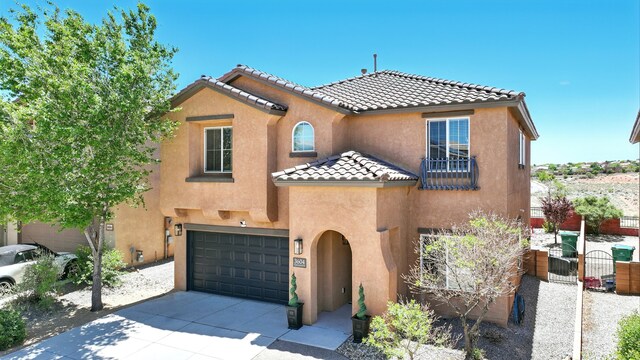 3604 Plano Vista Rd NE, Rio Rancho, NM 87124 - view of front of house with a tile roof, stucco siding, concrete driveway, an attached garage, and a gate