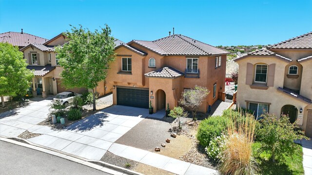 3604 Plano Vista Rd NE, Rio Rancho, NM 87124 - mediterranean / spanish home featuring stucco siding, concrete driveway, an attached garage, and a tile roof