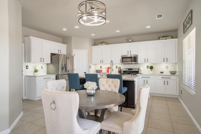 3604 Plano Vista Rd NE, Rio Rancho, NM 87124 - dining space with light tile patterned floors, baseboards, a chandelier, and recessed lighting