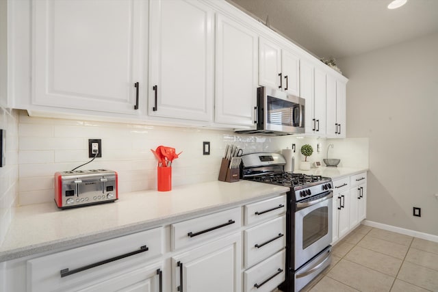 3604 Plano Vista Rd NE, Rio Rancho, NM 87124 - kitchen featuring stainless steel appliances, white cabinetry, light tile patterned floors, and backsplash