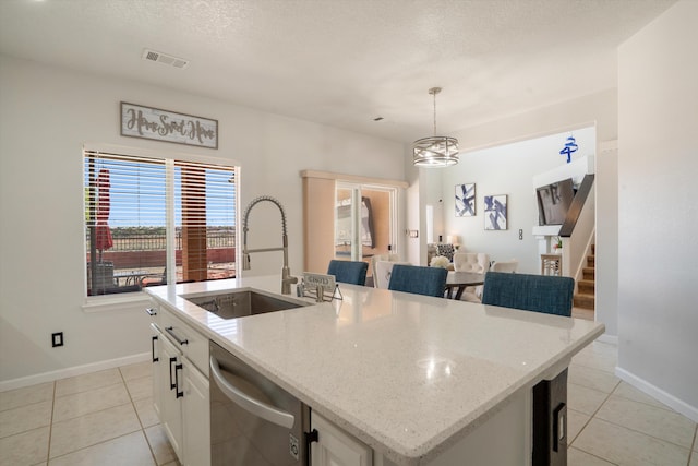 3604 Plano Vista Rd NE, Rio Rancho, NM 87124 - kitchen featuring dishwasher, a sink, light tile patterned flooring, a center island with sink, and baseboards