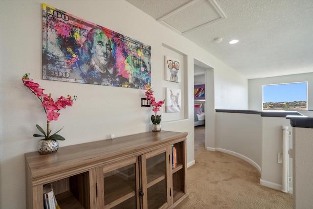 3604 Plano Vista Rd NE, Rio Rancho, NM 87124 - corridor with carpet, a textured ceiling, baseboards, and attic access