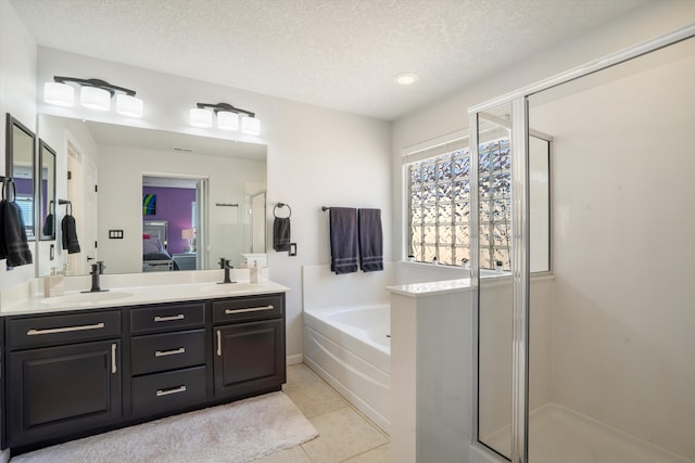3604 Plano Vista Rd NE, Rio Rancho, NM 87124 - full bathroom featuring a shower stall, double vanity, a garden tub, a textured ceiling, and connected bathroom