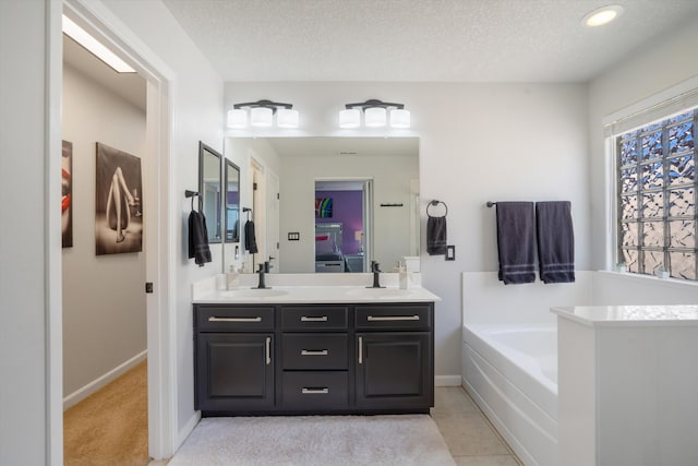 3604 Plano Vista Rd NE, Rio Rancho, NM 87124 - full bathroom with double vanity, a bath, baseboards, a textured ceiling, and recessed lighting
