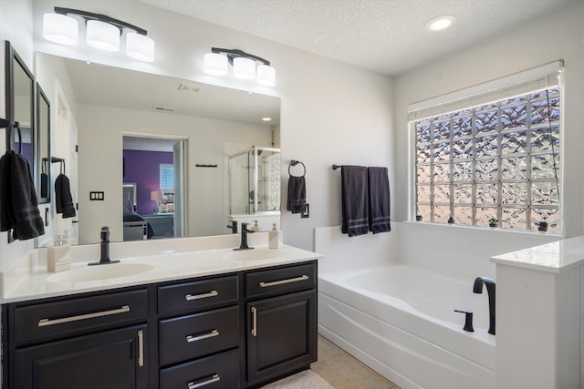 3604 Plano Vista Rd NE, Rio Rancho, NM 87124 - bathroom with a garden tub, a stall shower, double vanity, a textured ceiling, and tile patterned floors