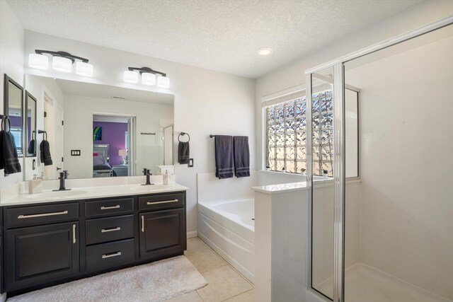 3604 Plano Vista Rd NE, Rio Rancho, NM 87124 - ensuite bathroom featuring a stall shower, double vanity, a bath, a textured ceiling, and tile patterned flooring