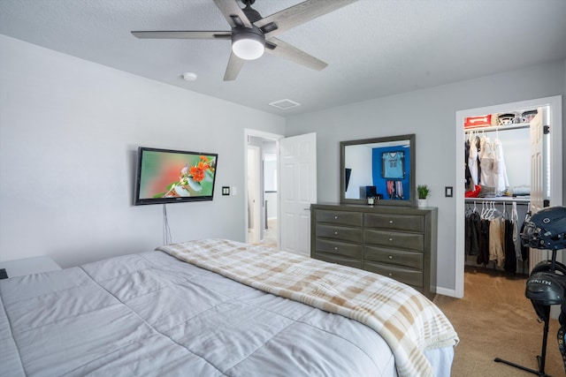 3604 Plano Vista Rd NE, Rio Rancho, NM 87124 - carpeted bedroom featuring a walk in closet, a closet, ceiling fan, and a textured ceiling
