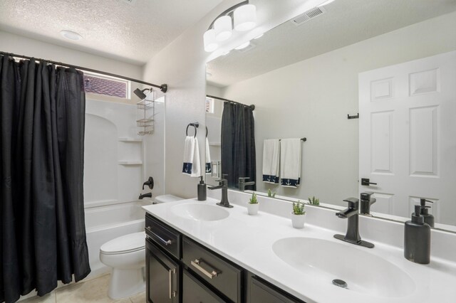3604 Plano Vista Rd NE, Rio Rancho, NM 87124 - full bath featuring double vanity, a textured ceiling, shower / tub combo with curtain, and tile patterned flooring
