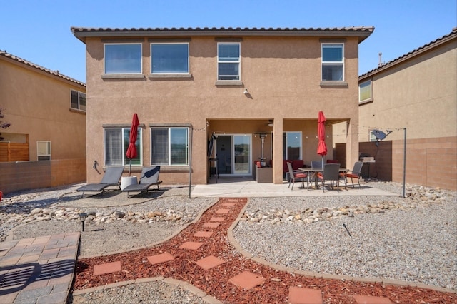 3604 Plano Vista Rd NE, Rio Rancho, NM 87124 - back of property with stucco siding, a patio area, and a fenced backyard