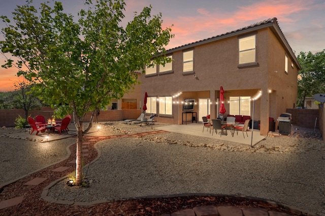 3604 Plano Vista Rd NE, Rio Rancho, NM 87124 - back of house with a patio, stucco siding, a fenced backyard, and an outdoor living space with a fire pit