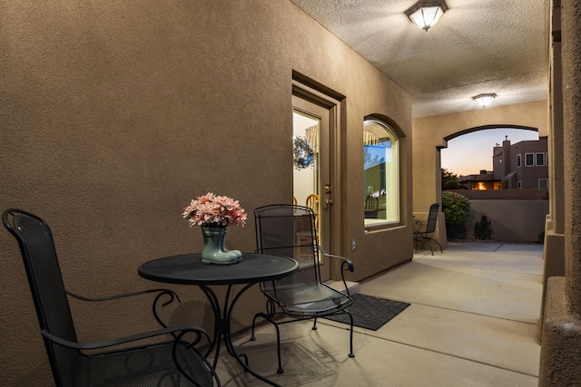 3916 Alamogordo Dr NW, Albuquerque, NM 87120 - dining area featuring a textured wall, finished concrete floors, a textured ceiling, and arched walkways