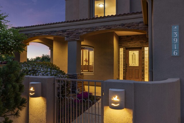 3916 Alamogordo Dr NW, Albuquerque, NM 87120 - view of front facade with stone siding, stucco siding, and a porch