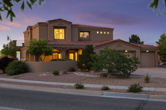 3916 Alamogordo Dr NW, Albuquerque, NM 87120 - mediterranean / spanish-style home featuring driveway, a garage, a tile roof, and stucco siding