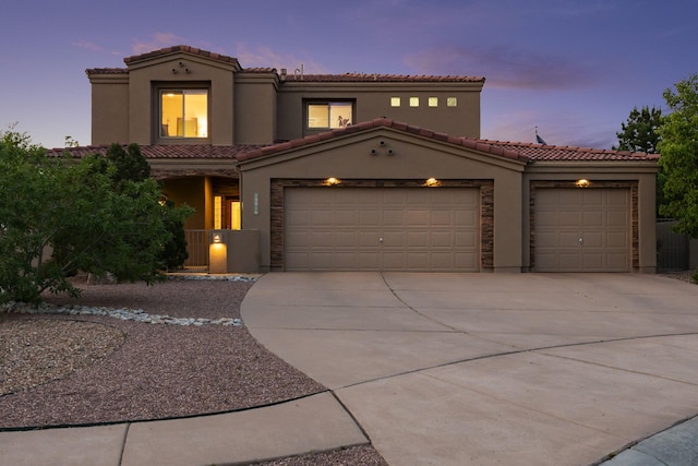 3916 Alamogordo Dr NW, Albuquerque, NM 87120 - mediterranean / spanish home with an attached garage, driveway, a tile roof, and stucco siding