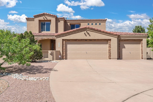 3916 Alamogordo Dr NW, Albuquerque, NM 87120 - mediterranean / spanish home with stucco siding, driveway, an attached garage, and a tile roof