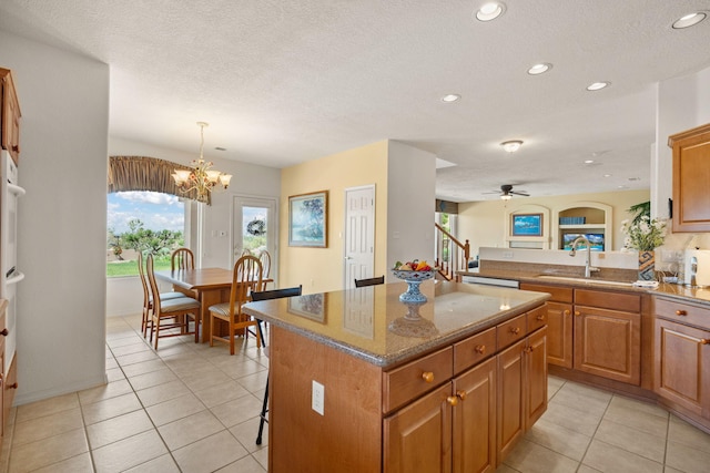 3916 Alamogordo Dr NW, Albuquerque, NM 87120 - kitchen with a center island, a sink, brown cabinets, recessed lighting, and healthy amount of natural light