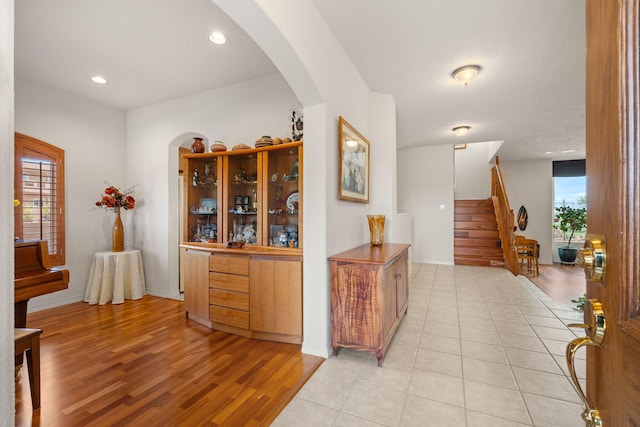 3916 Alamogordo Dr NW, Albuquerque, NM 87120 - hallway featuring arched walkways, stairs, light wood-type flooring, baseboards, and recessed lighting