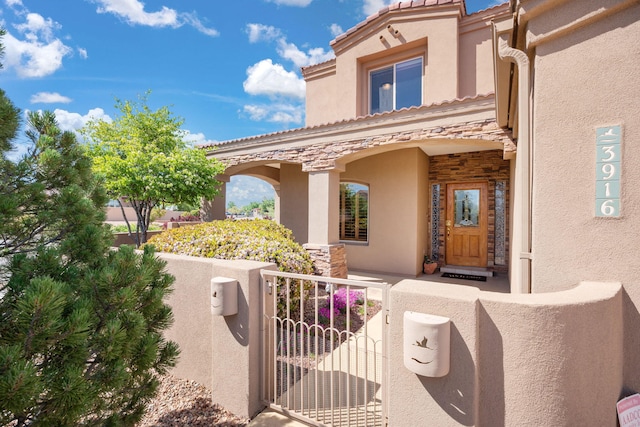 3916 Alamogordo Dr NW, Albuquerque, NM 87120 - view of front of property featuring stucco siding, a gate, stone siding, a fenced front yard, and a tile roof