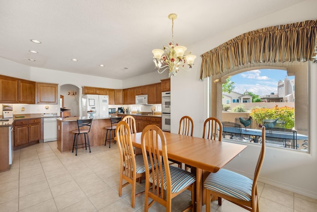 3916 Alamogordo Dr NW, Albuquerque, NM 87120 - dining area with a chandelier, recessed lighting, light tile patterned floors, and arched walkways