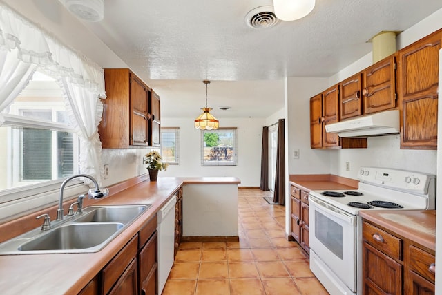 1595 W Bosque Loop, Bosque Farms, NM 87068 - kitchen featuring white appliances, under cabinet range hood, light countertops, healthy amount of natural light, and a textured ceiling
