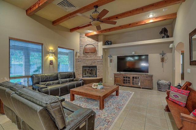 3924 Bay Hill Loop SE, Rio Rancho, NM 87124 - living room featuring ceiling fan, light tile patterned floors, beam ceiling, a stone fireplace, and arched walkways