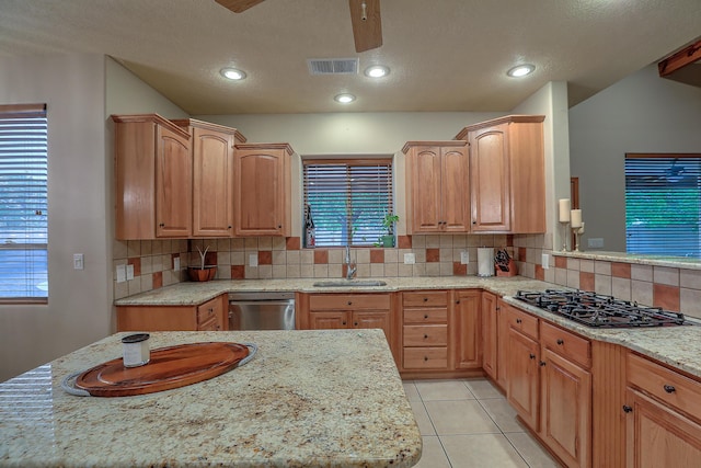 3924 Bay Hill Loop SE, Rio Rancho, NM 87124 - kitchen featuring black gas stovetop, a sink, stainless steel dishwasher, decorative backsplash, and a ceiling fan