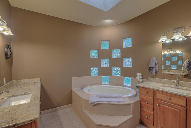 3924 Bay Hill Loop SE, Rio Rancho, NM 87124 - bathroom featuring tile patterned floors, a bath, two vanities, baseboards, and a skylight