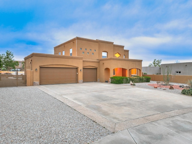 3924 Bay Hill Loop SE, Rio Rancho, NM 87124 - pueblo-style home featuring stucco siding, concrete driveway, and an attached garage