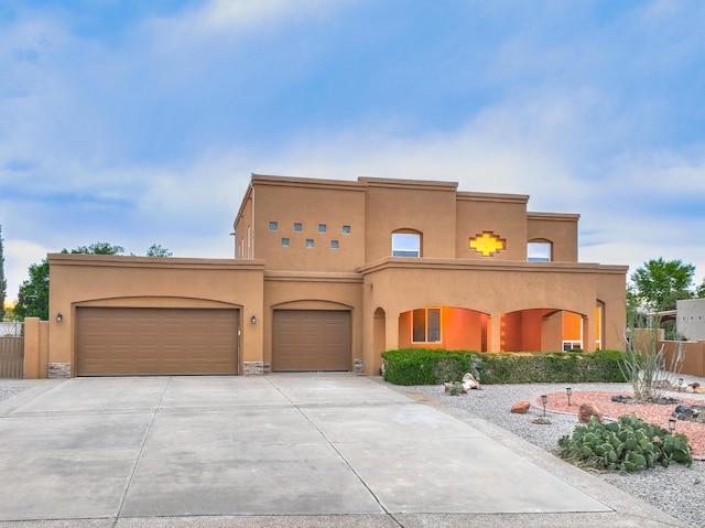 3924 Bay Hill Loop SE, Rio Rancho, NM 87124 - view of front of house with stucco siding, driveway, and a garage