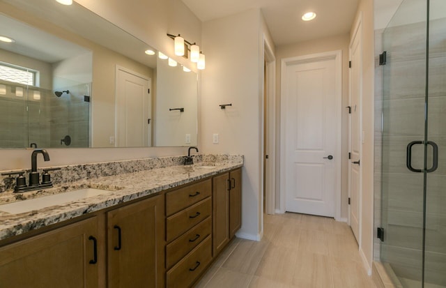 8328 Bronte Ln NW, Albuquerque, NM 87120 - bathroom featuring a stall shower, double vanity, recessed lighting, and baseboards