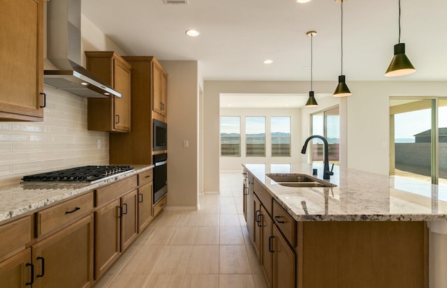8328 Bronte Ln NW, Albuquerque, NM 87120 - kitchen with wall chimney exhaust hood, a sink, appliances with stainless steel finishes, a kitchen island with sink, and brown cabinets
