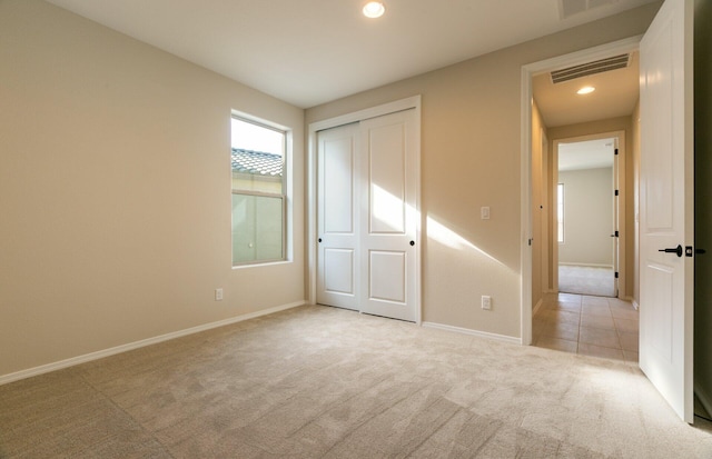 8328 Bronte Ln NW, Albuquerque, NM 87120 - unfurnished bedroom with light colored carpet, baseboards, recessed lighting, and a closet