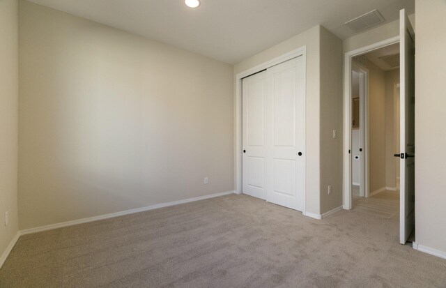 8328 Bronte Ln NW, Albuquerque, NM 87120 - unfurnished bedroom featuring light carpet, a closet, baseboards, and recessed lighting