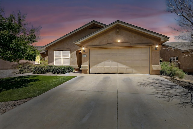 1250 Carnival Ave NW, Los Lunas, NM 87031 - ranch-style house featuring driveway, stucco siding, a garage, and a lawn