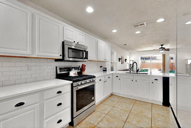 1250 Carnival Ave NW, Los Lunas, NM 87031 - kitchen featuring stainless steel appliances, a sink, decorative backsplash, recessed lighting, and light countertops