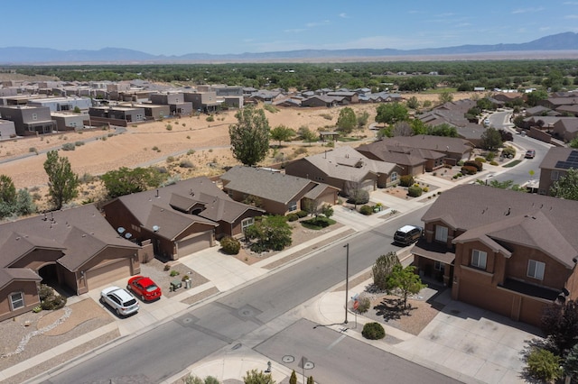 1250 Carnival Ave NW, Los Lunas, NM 87031 - aerial perspective of suburban area featuring a mountain backdrop