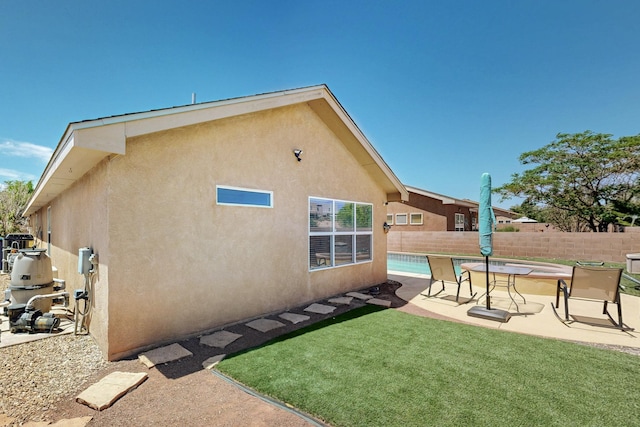 1250 Carnival Ave NW, Los Lunas, NM 87031 - back of property featuring stucco siding and a patio