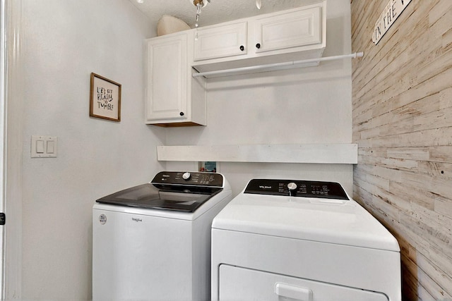 1250 Carnival Ave NW, Los Lunas, NM 87031 - laundry area with cabinet space, washing machine and dryer, and wooden walls