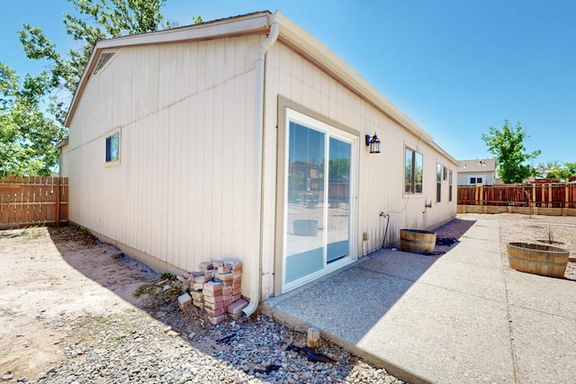 1321 Elkslip Dr NE, Rio Rancho, NM 87144 - view of side of home with a fenced backyard and a patio area