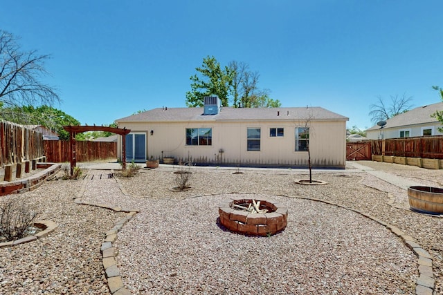 1321 Elkslip Dr NE, Rio Rancho, NM 87144 - back of house with a fire pit, a patio area, and a fenced backyard