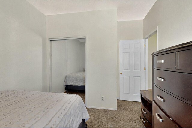 1321 Elkslip Dr NE, Rio Rancho, NM 87144 - carpeted bedroom with a closet and baseboards