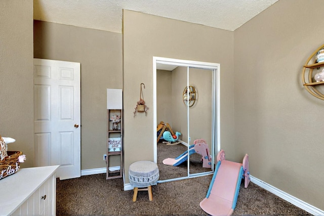 1321 Elkslip Dr NE, Rio Rancho, NM 87144 - bedroom with dark colored carpet, a textured ceiling, and baseboards
