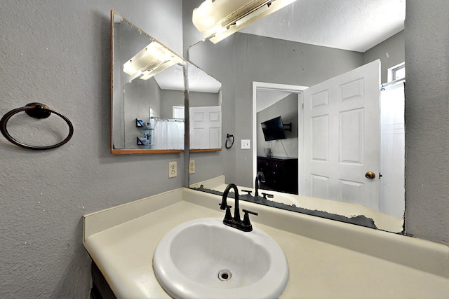 1321 Elkslip Dr NE, Rio Rancho, NM 87144 - bathroom featuring a textured wall and vanity