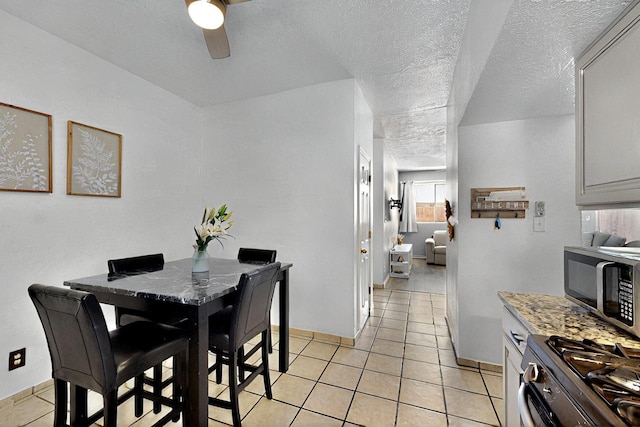 1321 Elkslip Dr NE, Rio Rancho, NM 87144 - dining room with a ceiling fan, light tile patterned floors, a textured ceiling, and baseboards