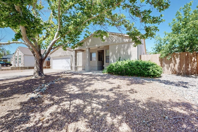 1321 Elkslip Dr NE, Rio Rancho, NM 87144 - single story home with stucco siding, fence, an attached garage, and concrete driveway