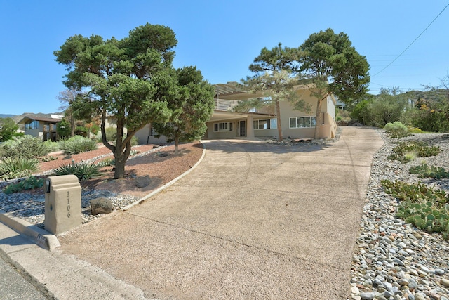 1106 Warm Sands Dr SE, Albuquerque, NM 87123 - view of front of home with concrete driveway and stucco siding