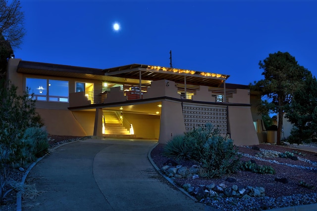 1106 Warm Sands Dr SE, Albuquerque, NM 87123 - view of front of house with driveway, stucco siding, and a balcony