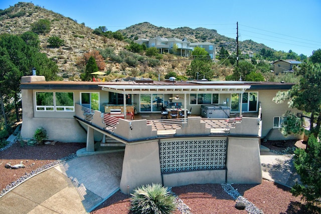 1106 Warm Sands Dr SE, Albuquerque, NM 87123 - view of front of house with a hot tub, a mountain view, and a patio area