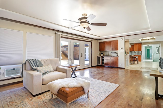 1106 Warm Sands Dr SE, Albuquerque, NM 87123 - living room featuring beverage cooler, a raised ceiling, light wood finished floors, and a ceiling fan